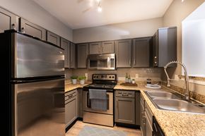 Houston apartment for rent - A modern kitchen with a stainless steel refrigerator and oven.