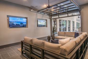 San Antonio apartment for rent - A living room with a couch and a television on the wall.