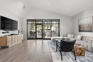 Austin apartment for rent - A modern living room with a black chair and a large painting on the wall.
