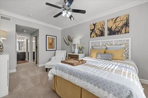 Austin apartment for rent - A bedroom with a large bed and a ceiling fan.