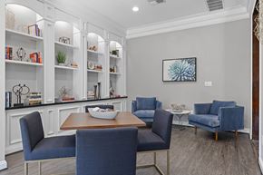 Houston apartment for rent - A dining room with a wooden table and blue chairs.