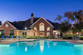 Houston apartment for rent - A large house with a pool in front.