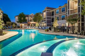 Spring apartment for rent - A swimming pool with a slide in the middle of it.
