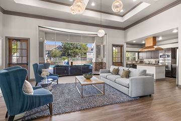 Broomfield apartment for rent - A modern living room with a blue chair and a grey sofa.