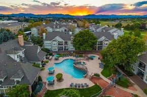 Broomfield apartment for rent - A sunset view of a residential area with a swimming pool.