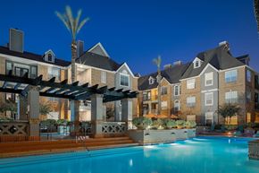 Houston apartment for rent - A swimming pool in front of apartment buildings.