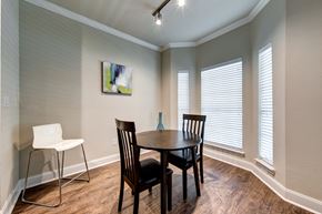 Houston apartment for rent - A dining room with a table, chairs and a painting on the wall.