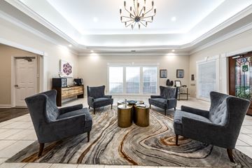 Houston apartment for rent - A living room with grey chairs and a rug.