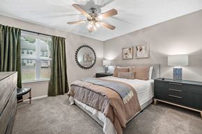 Flower Mound apartment for rent - a bedroom with a bed and a ceiling fan