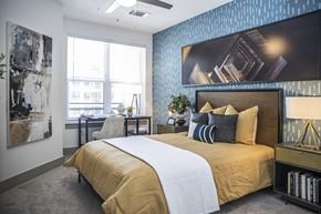 Atlanta apartment for rent - A bedroom with a large bed and a painting on the wall.