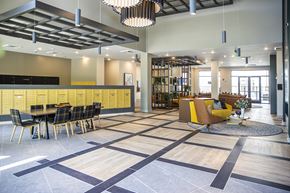 Atlanta apartment for rent - A large open space with a dining area and a yellow sofa.