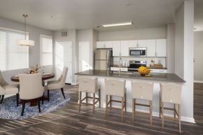 Englewood apartment for rent - an open kitchen and dining room with a large island and chairs