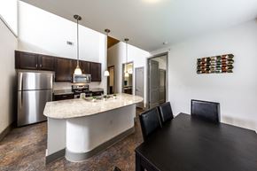 Austin apartment for rent - A kitchen with a black table and a white counter.