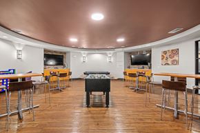 Austin apartment for rent - A room with a pool table and bar stools.