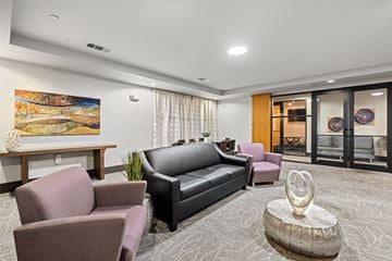 Austin apartment for rent - A living room with a grey carpet and a painting on the wall.