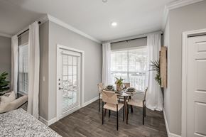 Kingwood apartment for rent - A dining room with a table set for two and a view of the outside.