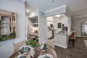 Kingwood apartment for rent - A modern kitchen and dining area with a table set for a meal.