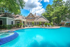 Kingwood apartment for rent - A large house with a pool in front.