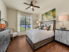 Austin apartment for rent - a bedroom with a bed and a ceiling fan