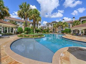 Austin apartment for rent - a large swimming pool with houses in the background