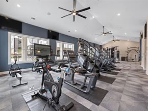 Austin apartment for rent - A gym with a variety of exercise equipment including treadmills, stationary bikes, and weight machines.
