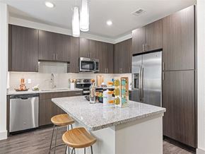 Dallas apartment for rent - a kitchen with a counter top and a refrigerator