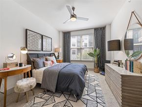 Dallas apartment for rent - a bedroom with a bed and a ceiling fan