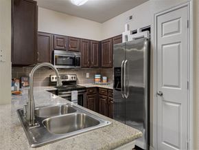 Kingwood apartment for rent - A kitchen with a stainless steel refrigerator and a sink.