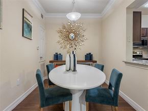 Kingwood apartment for rent - A dining room with a white table and blue chairs.