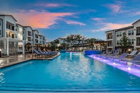 Leander apartment for rent - a large swimming pool in front of an apartment building