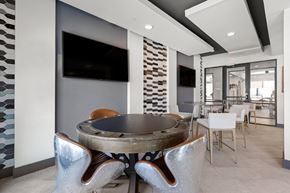 Huntsville apartment for rent - a conference room with a round table and chairs and a television