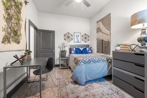 Huntsville apartment for rent - a bedroom with a bed and a desk and a window