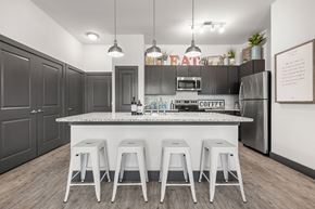 Huntsville apartment for rent - a kitchen with a large island with bar stools
