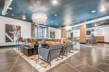 Roanoke apartment for rent - A modern living room with a large sofa set and a chandelier.