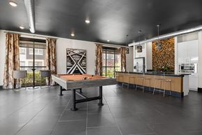 Roanoke apartment for rent - A modern kitchen with a pool table in the middle.