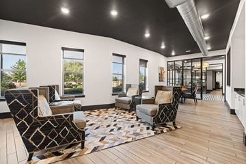 Roanoke apartment for rent - A living room with a patterned rug and a black and white chair.