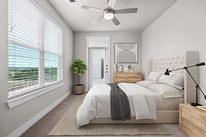 Leander apartment for rent - an open bedroom with a bed and a ceiling fan