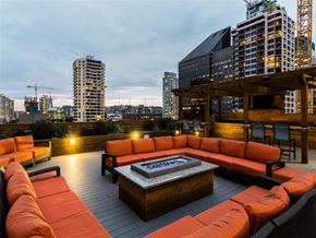 Seattle apartment for rent - A rooftop patio with orange couches and a fire pit.