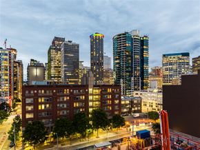 Seattle apartment for rent - A cityscape with a mix of modern and older buildings, with a construction site in the foreground.