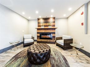 Seattle apartment for rent - A living room with a fireplace and a chair.