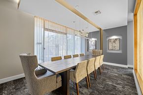 Austin apartment for rent - a dining room with a long wooden table and chairs