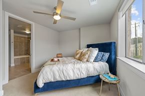 Austin apartment for rent - a bedroom with a bed and a ceiling fan
