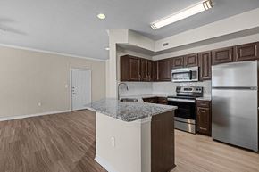 Plano apartment for rent - a kitchen with stainless steel appliances and a granite counter top