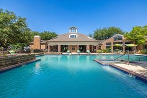 Plano apartment for rent - a large swimming pool with a house in the background