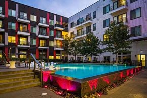Austin apartment for rent - a swimming pool at night in front of an apartment building