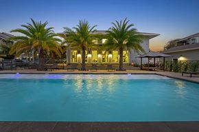 Austin apartment for rent - A swimming pool in front of a house with a palm tree.