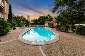 Austin apartment for rent - A round swimming pool surrounded by a gravel area with a sign that says "NO DIVING".
