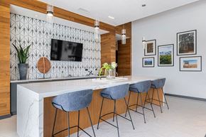 Westminster apartment for rent - a kitchen with a marble counter top and chairs
