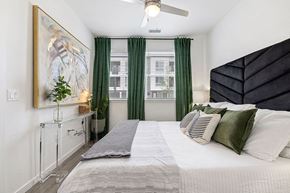 Westminster apartment for rent - a bedroom with a large bed and green curtains