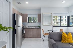 Hialeah apartment for rent - a kitchen and living room with a refrigerator and a sink
